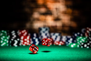 A Very Close Up Shot Of 2 Dice Rolling On Table